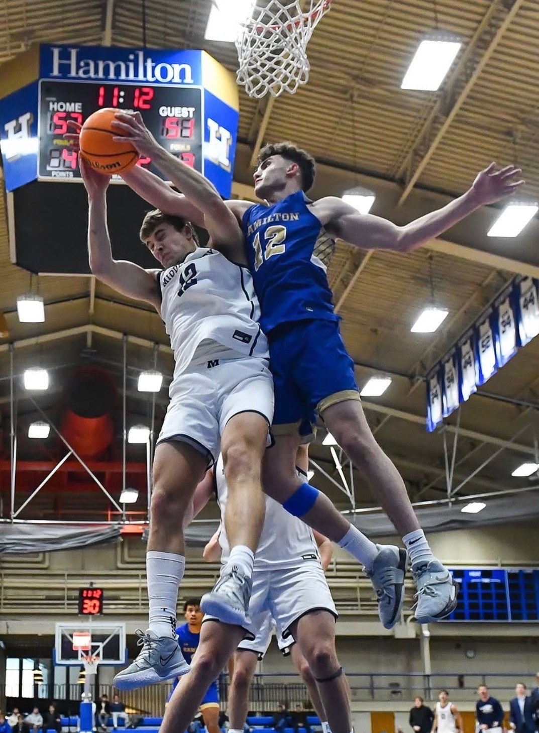 Garret Keyhani, number 12 for Hamilton, contesting a rebound at the rim
