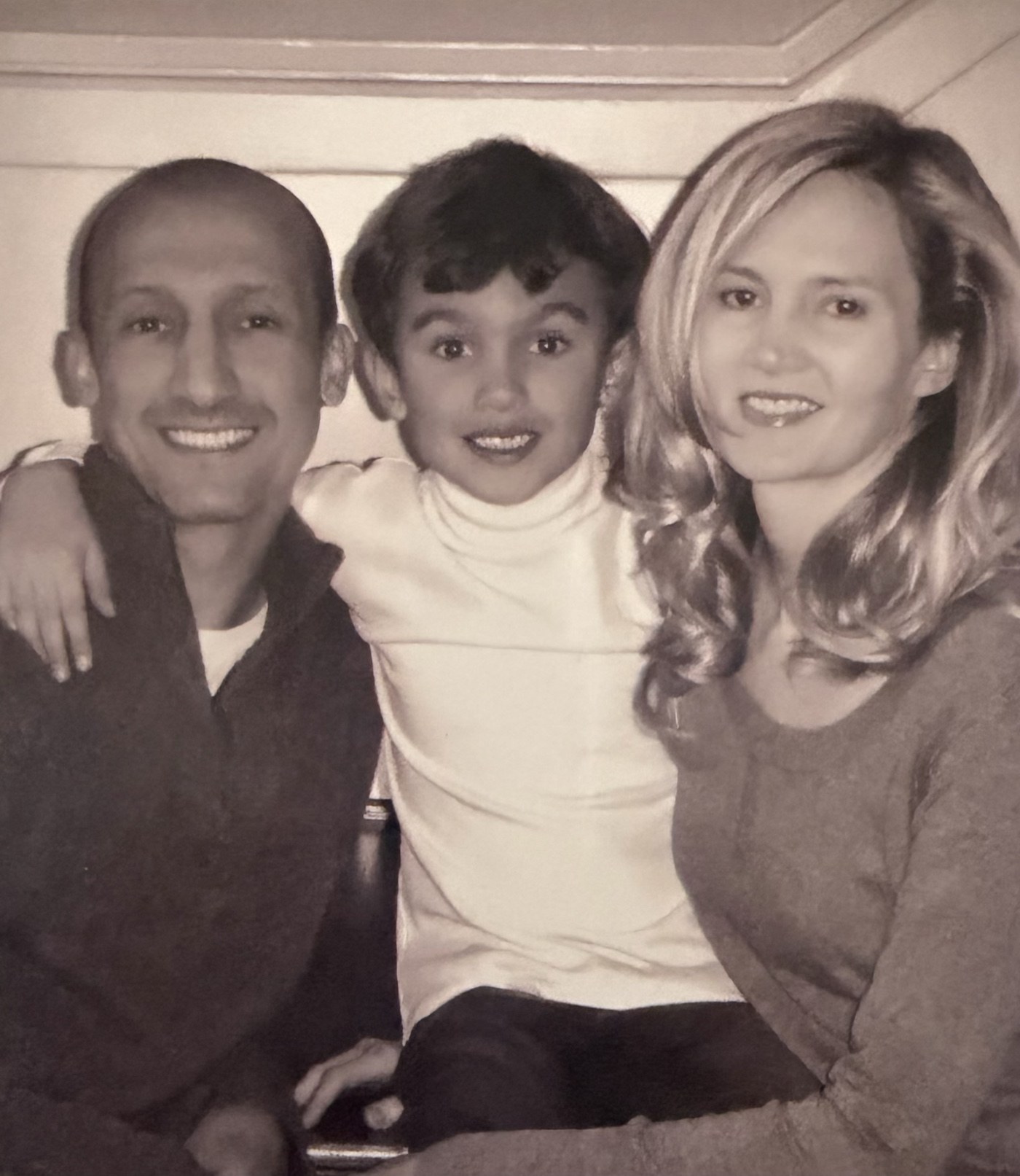 A young Garret with his mom and dad, all smiling